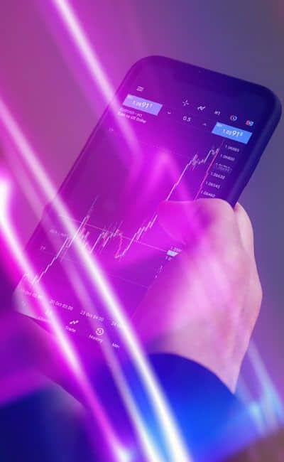 Smartphone displaying the MetaTrader 4 (MT4) mobile trading platform, representing real-time market access, chart analysis, and online trading on the INGOT website.