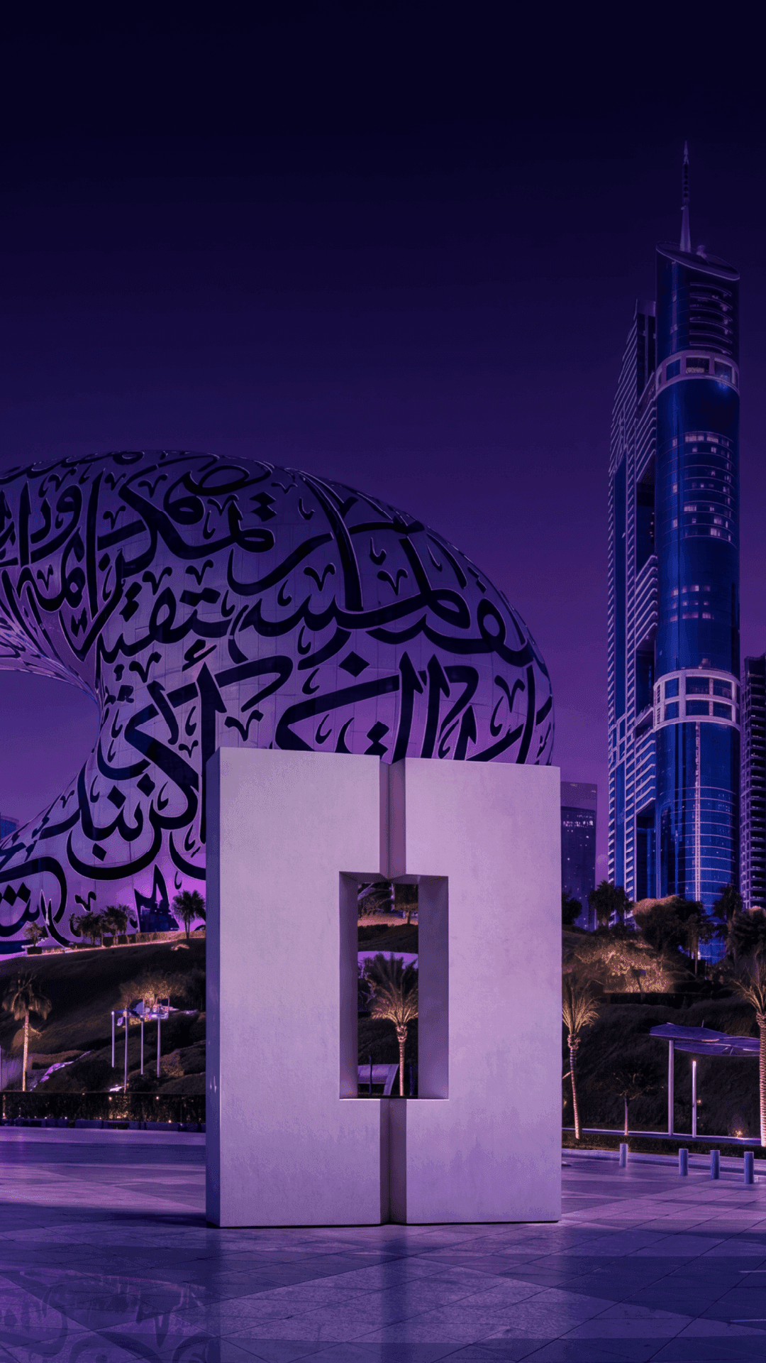 Dubai Museum of the Future and city skyline illuminated purple at night.