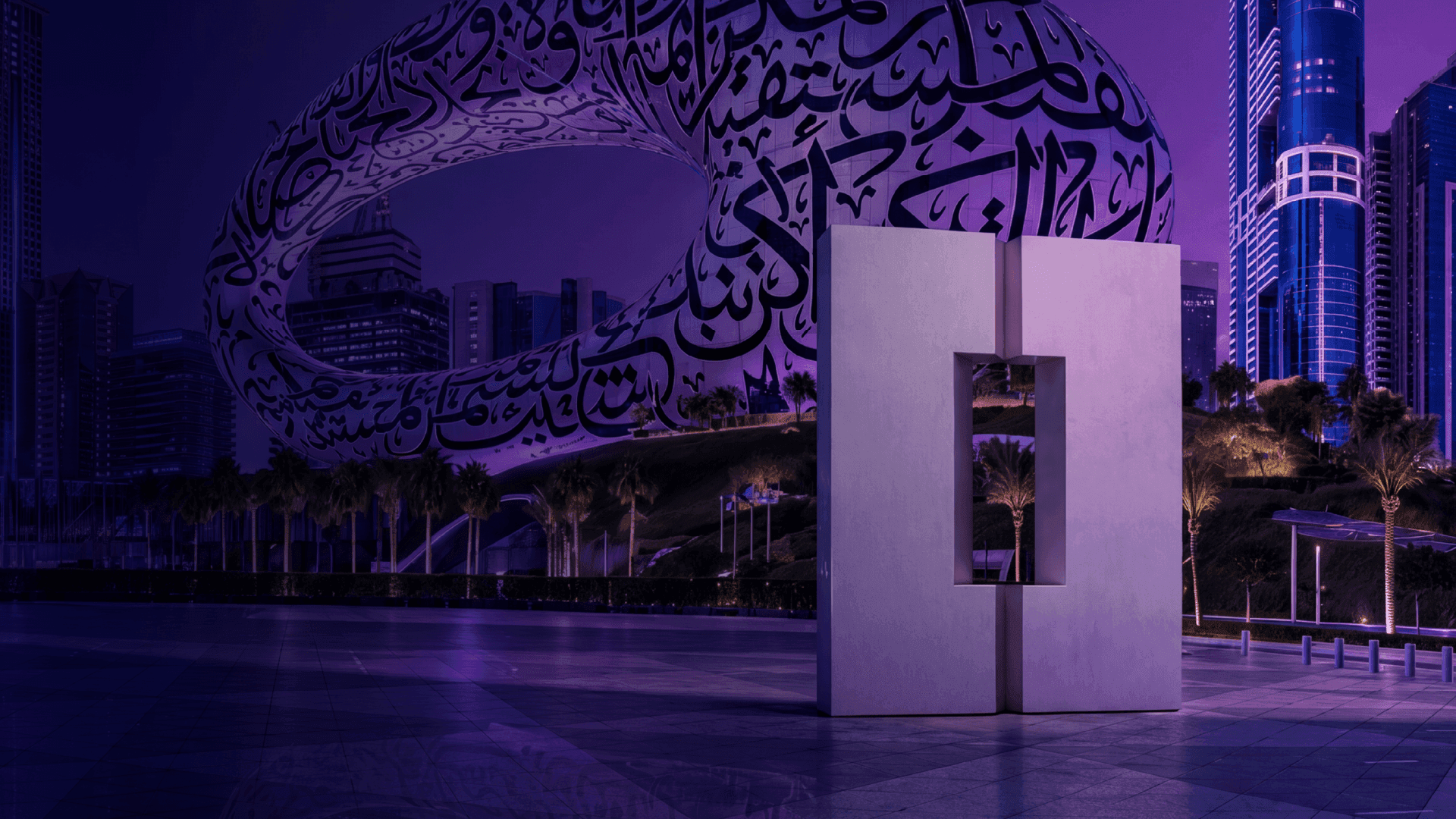 Futuristic Museum of the Future building in Dubai adorned with Arabic calligraphy at night.