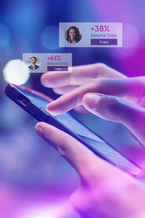 Person using the INGOT Copy Trading platform on a smartphone, allowing traders to follow and automatically copy experienced investors' strategies.