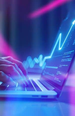 Laptop displaying financial market charts, representing INGOT's licensed, trusted, and reliable online trading services.