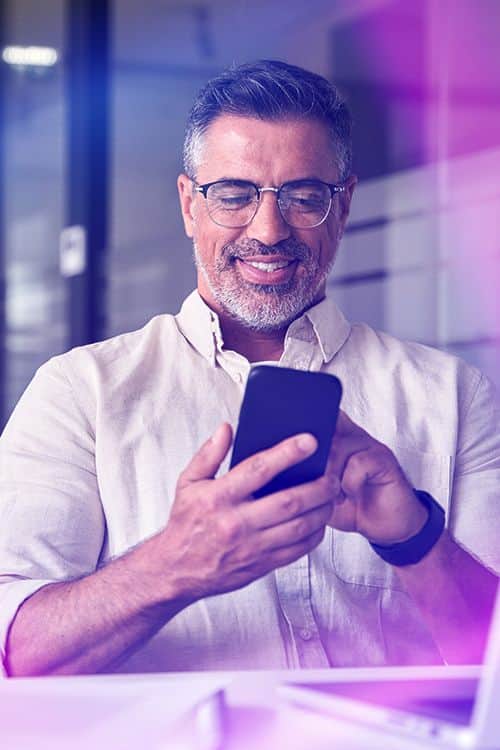 Person using the INGOT mobile trading app to monitor live financial markets, analyze price charts, and trade on the go.